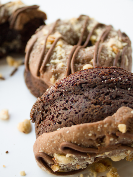 gluten free vegan chocolate hazelnut donuts against a white background