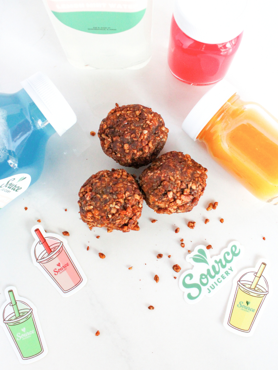 three protein power bites surrounded by colorful stickers and small glass juice bottles on a white background